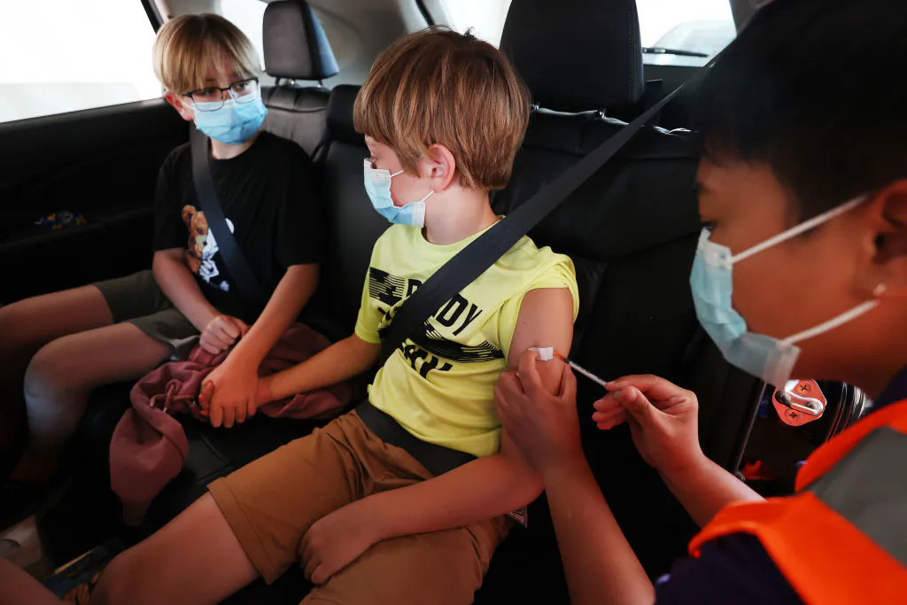 Two brothers at the drive-through vaccination centre at North Shore Events Centre in Auckland, New Zealand, on Jan. 17, 2022. (Fiona Goodall/Getty Images)