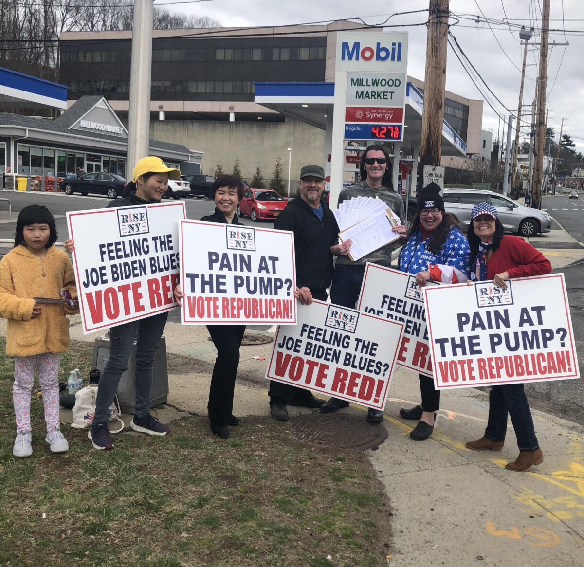 Scott Pressler posing for a group photo with volunteers while collecting voter registrations at a gas station in Nassau County, New York on March 26, 2022.