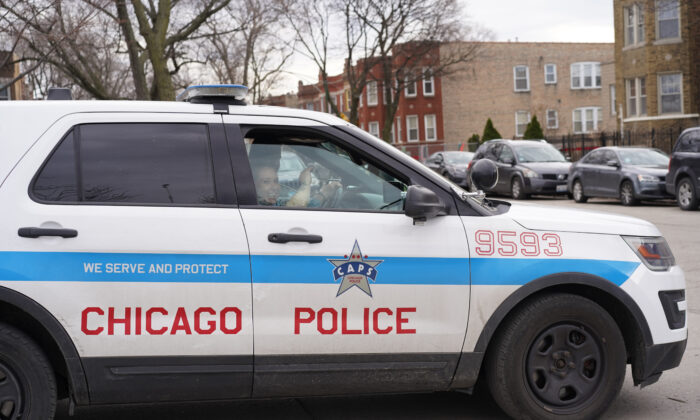 Chicago police officers patrol near a known open air drug market in the Humboldt Park neighborhood on the West Side of Chicago on April 11, 2022. (Cara Ding/The Epoch Times)