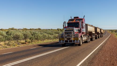 Truck driving on Stuart Highway between Darwin and Adelaide, Australia. (Serge/Adobe Stock)