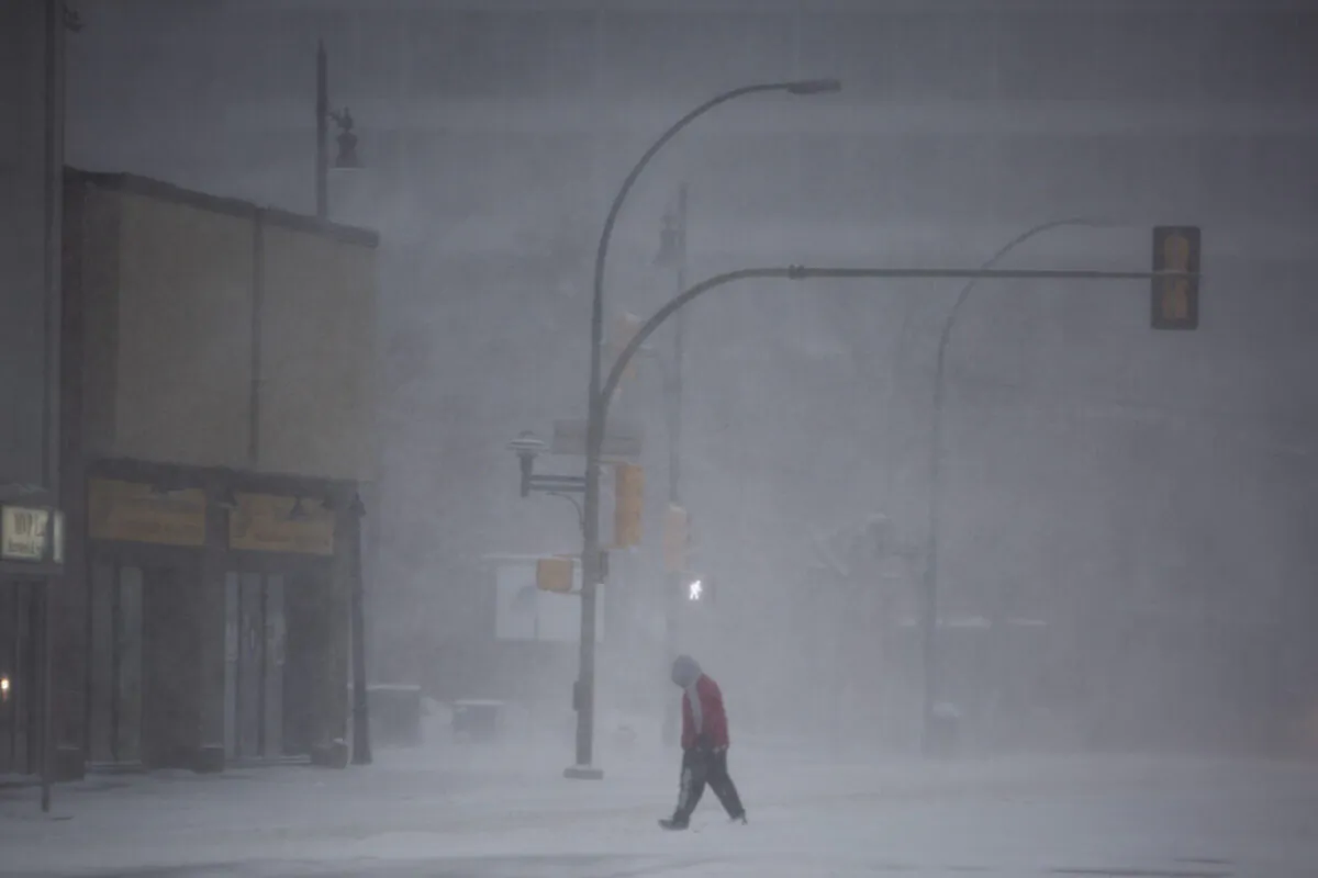 A pedestrian walks through the downtown area during a snowstorm in Saskatoon on November 8, 2020. (The Canadian Press/Kayle Neis)