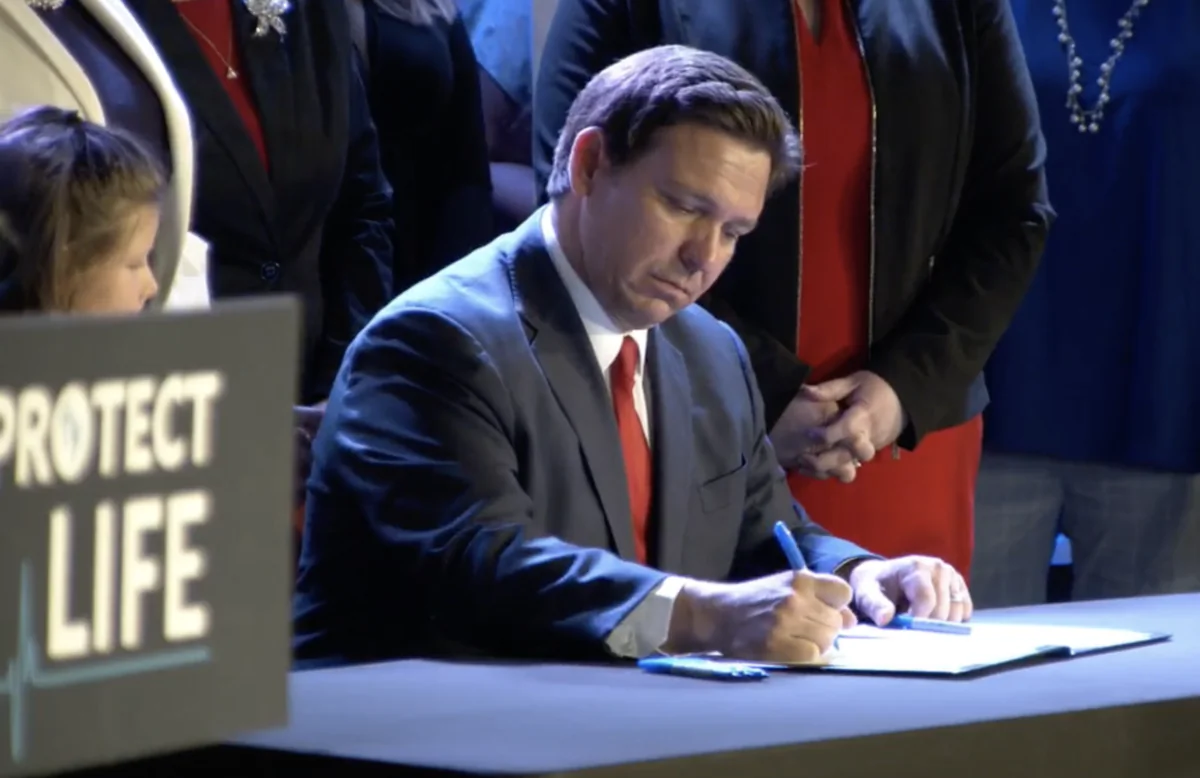 Florida Gov. Ron DeSantis signs HB-5 in Kissimmee on April 14, 2022. (Screenshot, Gov. Ron DeSantis Facebook page)