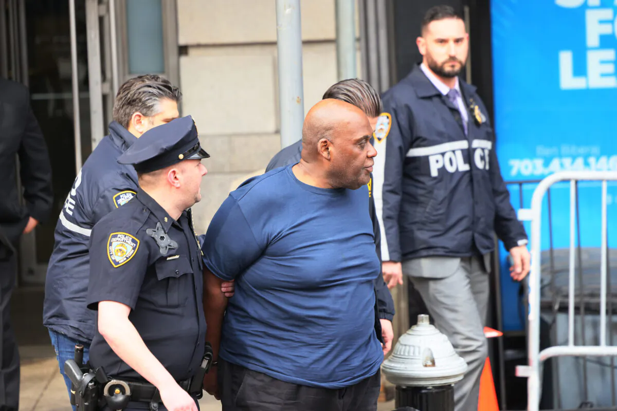 Suspect Frank James is led by police from the Ninth Precinct after being arrested for his connection to the shooting at the 36th St subway station in New York on April 13, 2022. (Michael M. Santiago/Getty Images)