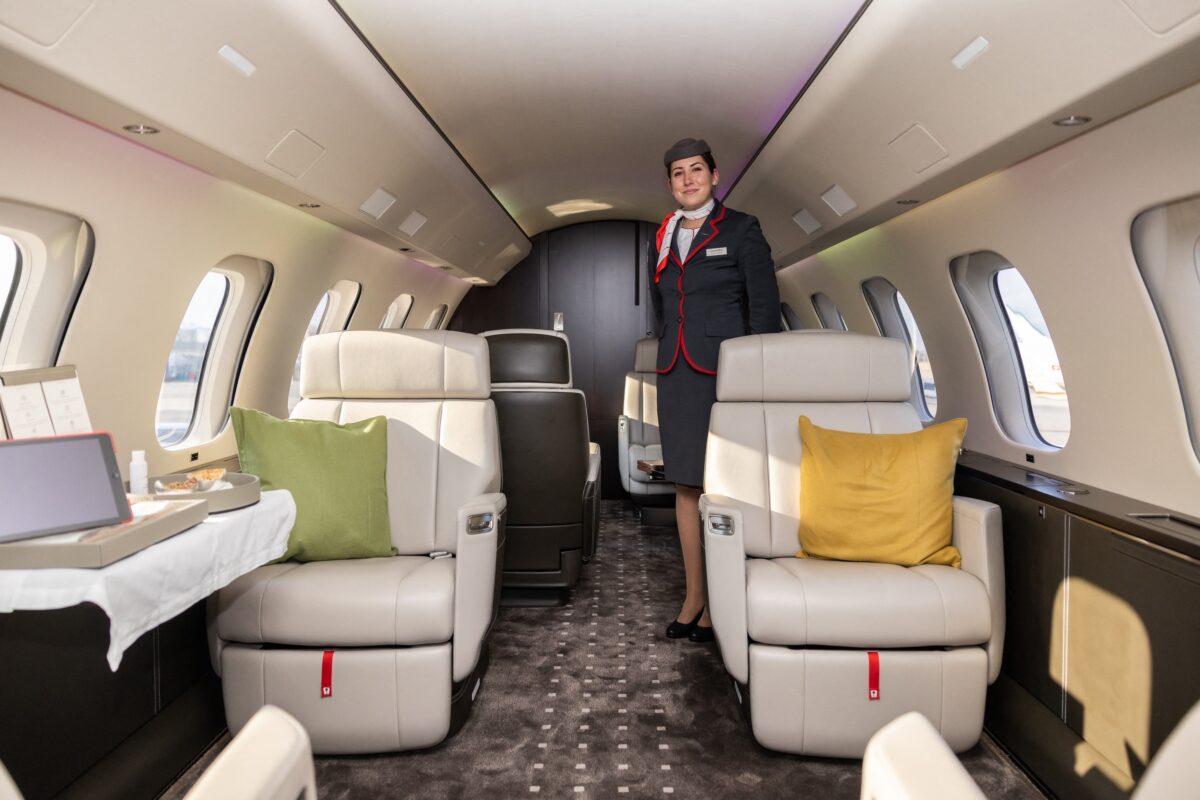 A cabin crew member poses inside a Bombardier Global 7500 business jet during a presentation of the brand new aircraft from the global business aviation company at Geneva airport on March 3, 2022. (PIERRE ALBOUY/AFP via Getty Images)