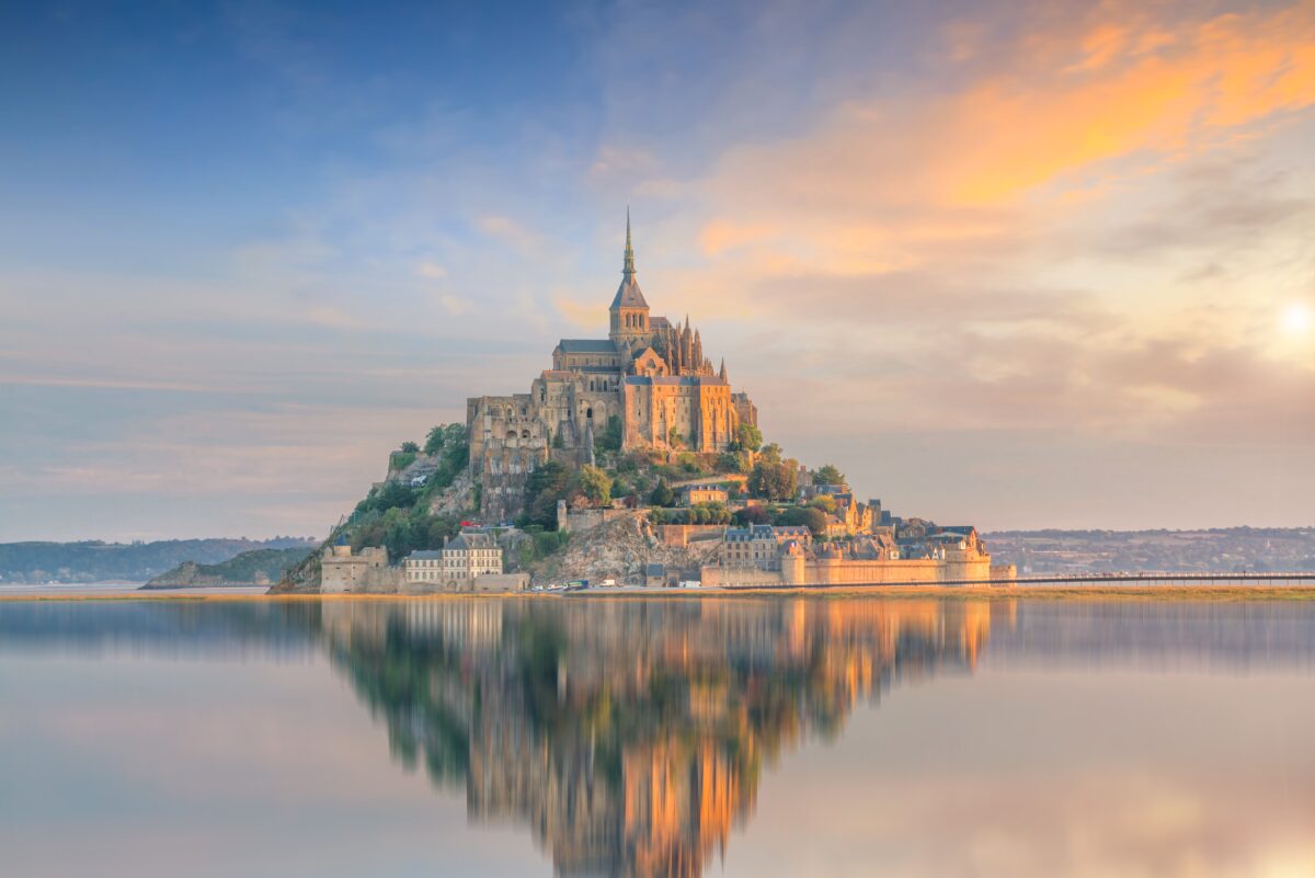 Mont Saint-Michel at sunset twilight in Normandy, northern France. (f11photo/Shutterstock)