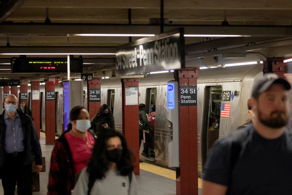 People walk at a subway platform a day after a Brooklyn subway station shooting incident, in Manhattan, New York, on April 13, 2022. (Andrew Kelly/Reuters)