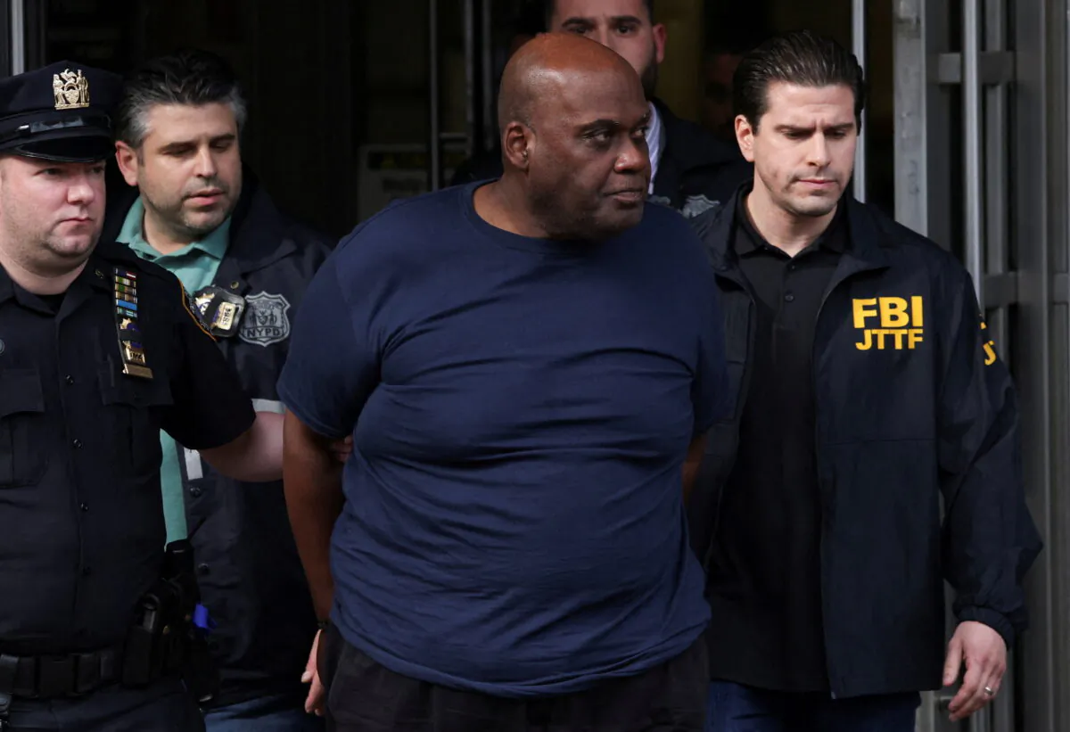 Frank James, the suspect in the Brooklyn subway shooting, walks outside a police precinct in New York City on April 13, 2022. (Andrew Kelly/Reuters)