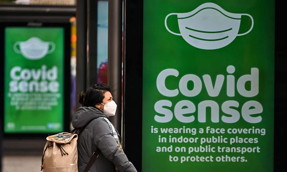 Members of the public walk along Princess Street in Edinburgh, Scotland, on March 15, 2022. (Jeff J Mitchell/Getty Images)
