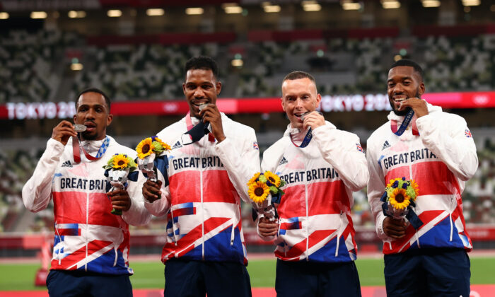 Silver medallists Chijindu Ujah of Britain, Zharnel Hughes of Britain, Richard Kilty of Britain and Nethaneel Mitchell-Blake of Britain pose on the podium during the Tokyo 2020 Olympics, on Aug. 7, 2021. (Andrew Boyers/Reuters)