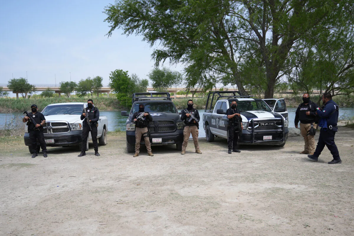 State and local Mexican police in Acuna, Mexico, by the Rio Grande border with Texas prepare to take photos for social media to show the area is safe for tourists during Easter, on April 15, 2022. (Charlotte Cuthbertson/The Epoch Times)