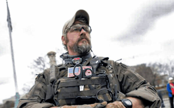 The "publicly available photo" of Jeremey Brown dressed in "tactical gear" in Washington D.C. on January 5, 2021. The "witness" identified Brown as being present at the Stop the Steal rally on January 6, 2021 by comparing it to photography and video from January 6, 2021.