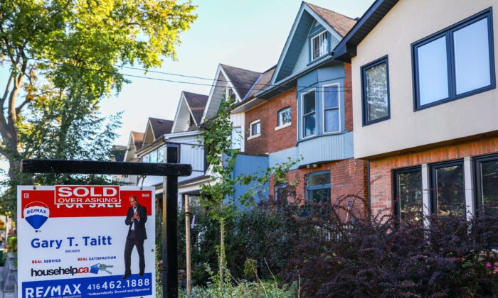 A sold sign in front of a Toronto home in a file photo. Mortgage rates are being kept high as the big banks play defence ahead of a potential recession. (The Canadian Press/Evan Buhler)