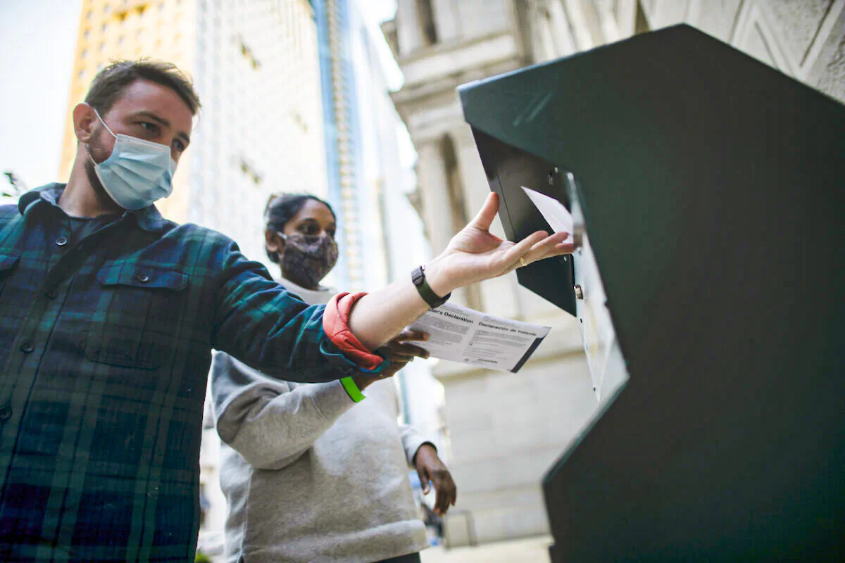 Voters cast their early voting ballot at drop box outside of City Hall in Philadelphia, Penn., on Oct. 17, 2020. (Mark Makela/Getty Images)