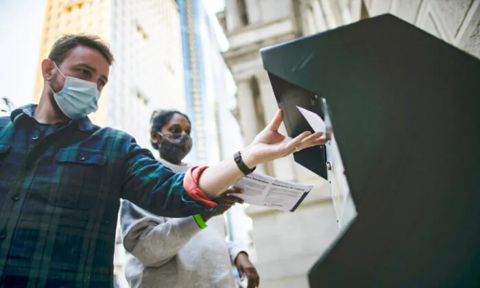 Voters cast their early voting ballot at drop box outside of City Hall in Philadelphia, Penn., on Oct. 17, 2020. (Mark Makela/Getty Images)
