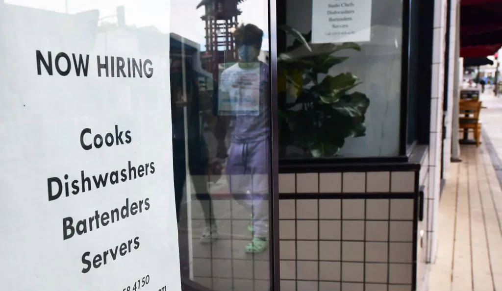 A "now hiring" sign is posted in the window of a restaurant in Los Angeles on January 28, 2022. (Frederic J. Brown/AFP via Getty Images)