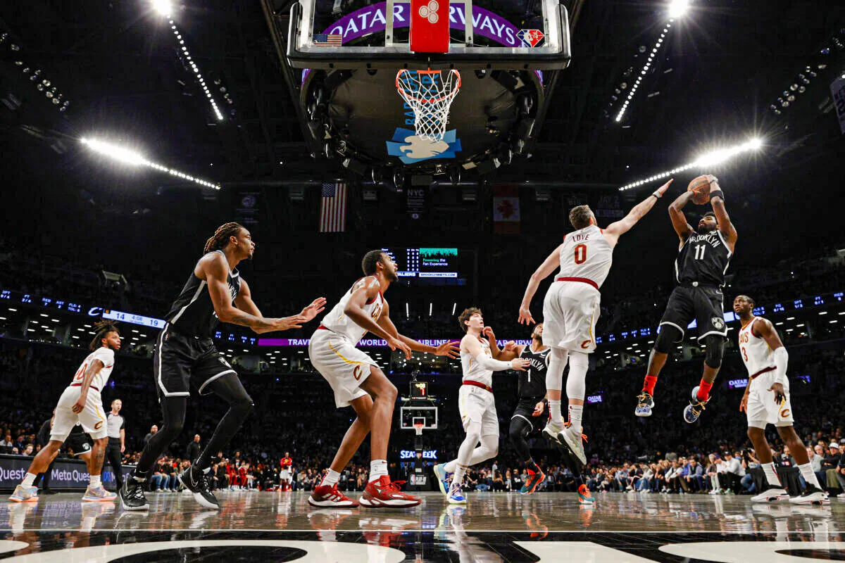 Kyrie Irving #11 of the Brooklyn Nets goes to the basket as Kevin Love #0 of the Cleveland Cavaliers defends during the Eastern Conference 2022 Play-In Tournament at Barclays Center, in the Brooklyn borough of New York, on April 12, 2022. (Sarah Stier/Getty Images)