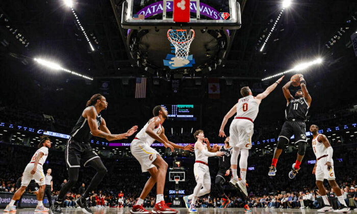 Kyrie Irving #11 of the Brooklyn Nets goes to the basket as Kevin Love #0 of the Cleveland Cavaliers defends during the Eastern Conference 2022 Play-In Tournament at Barclays Center, in the Brooklyn borough of New York, on April 12, 2022. (Sarah Stier/Getty Images)