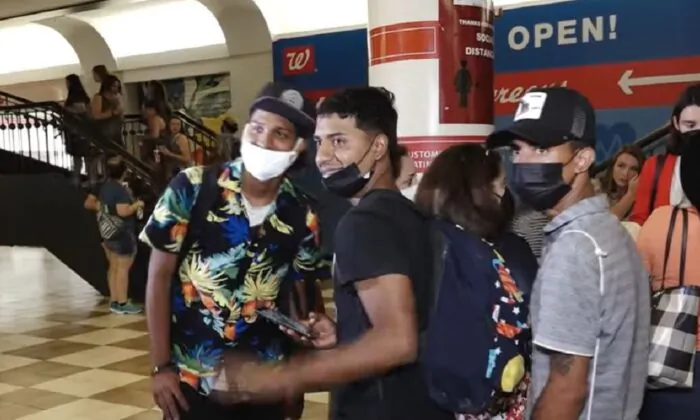 In this image from video, illegal immigrants from Texas gather in Union Station after being transported to Washington, on April 13, 2022. (NTD Television)