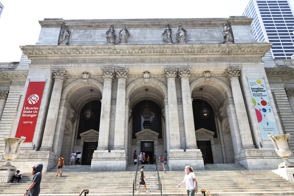 People walk along the stairs of the New York Public Library on July 6, 2021 in Manhattan in New York City. (Michael M. Santiago/Getty Images)