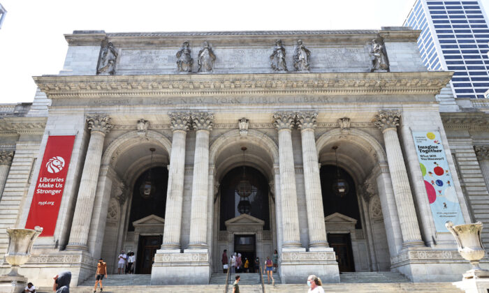 People walk along the stairs of the New York Public Library in Manhattan on July 6, 2021. (Michael M. Santiago/Getty Images)