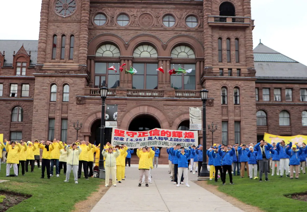 Toronto Falun Gong practitioners perform meditative exercises at the Ontario legislature during a gathering to commemorate the 23rd anniversary of Falun Gong adherents' mass appeal in Beijing, on April 14, 2022. (Michelle Hu/The Epoch Times)