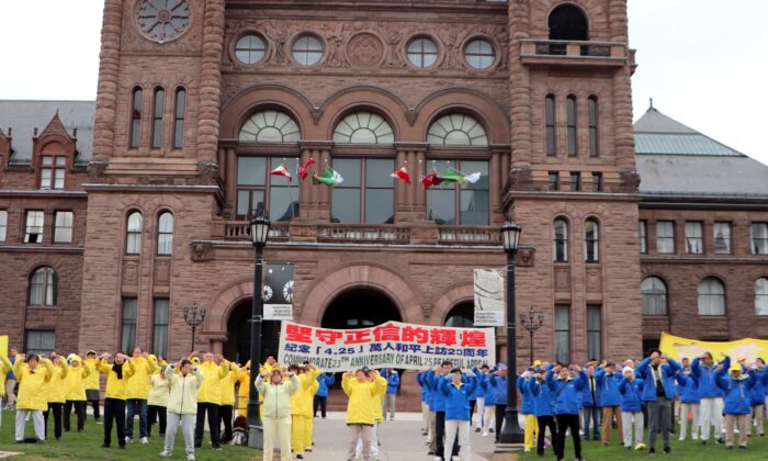 Toronto Falun Gong practitioners perform meditative exercises at the Ontario legislature during a gathering to commemorate the 23rd anniversary of Falun Gong adherents' mass appeal in Beijing, on April 14, 2022. (Michelle Hu/The Epoch Times)