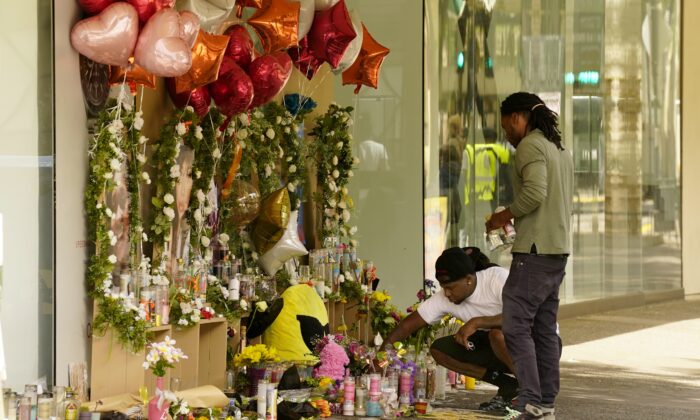 Mourners visit a memorial to victims of a recent mass shooting in Sacramento, Calif., on April 8, 2022. (Rich Pedroncelli/AP Photo)