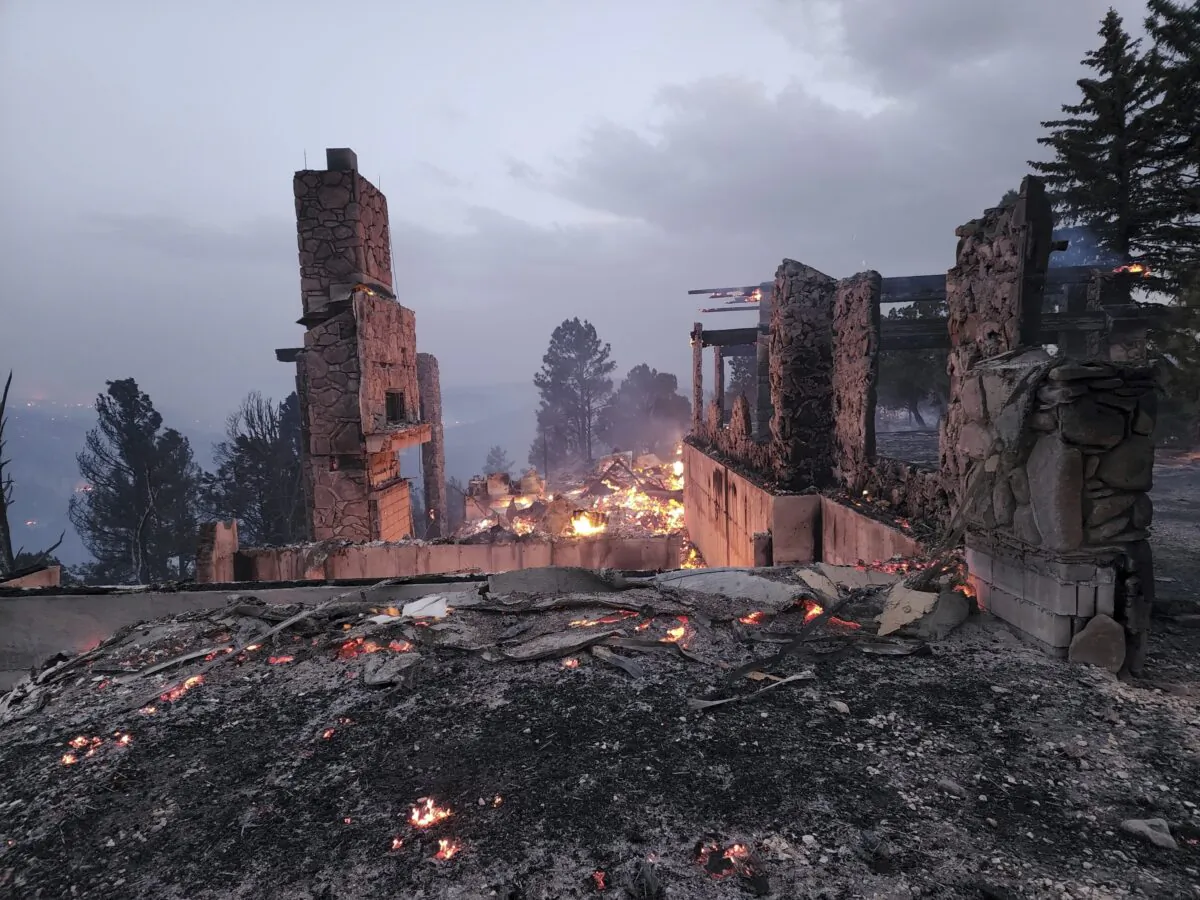 The remains of a home left after a wildfire spread through the Village of Ruidoso, N.M., on April 13, 2022. (Alexander Meditz via AP)