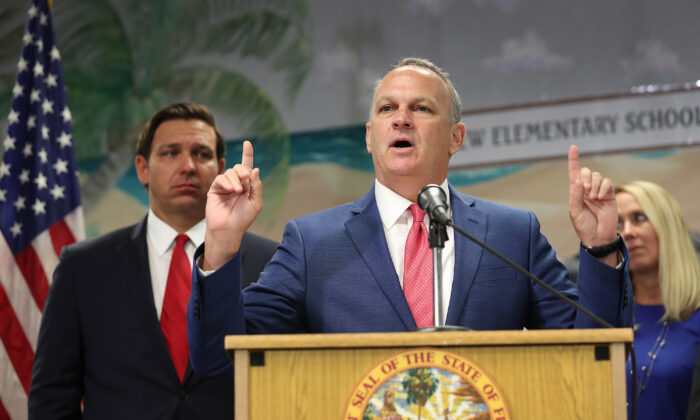 Florida Gov. Ron DeSantis (L) listens as Florida Education Commissioner Richard Corcoran speaks during a press conference at Bayview Elementary School in Fort Lauderdale, Fla., on Oct. 7, 2019. (Joe Raedle/Getty Images)