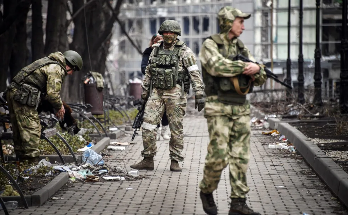 Russian soldiers walks along a street in Mariupol on April 12, 2022. (Alexander Nemenov/AFP via Getty Images)