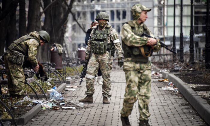 Russian soldiers walks along a street in Mariupol on April 12, 2022. (Alexander Nemenov/AFP via Getty Images)