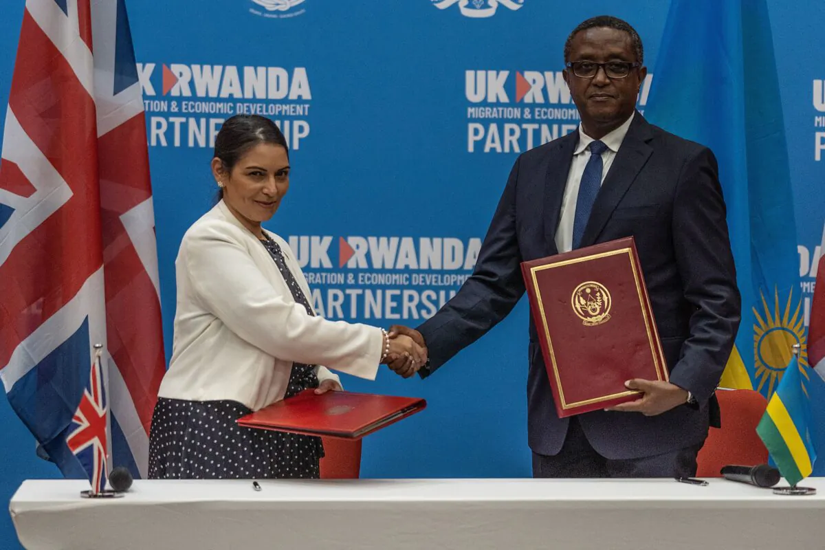 British Home Secretary Priti Patel (L) and Rwandan Minister of Foreign Affairs and International Cooperation Vincent Biruta shake hands after signing agreement in Kigali, Rwanda, on April 14, 2022. (Simon Wohlfahrt /AFP via Getty Images)