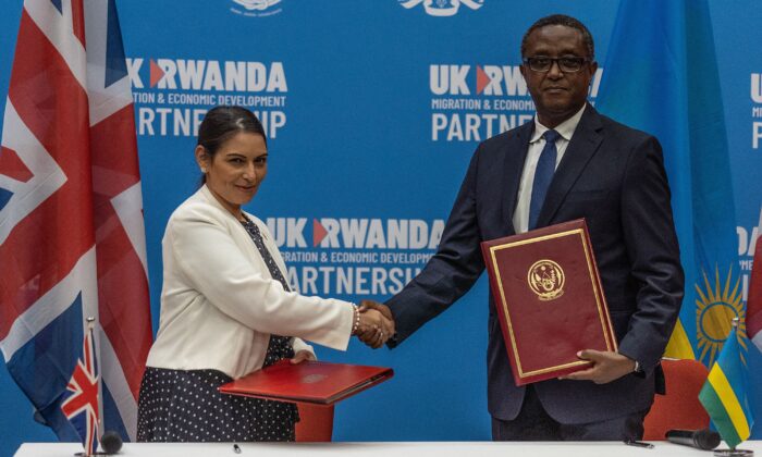 British Home Secretary Priti Patel (L) and Rwandan Minister of Foreign Affairs and International Cooperation Vincent Biruta shake hands after signing  agreement in Kigali, Rwanda, on April 14, 2022. (Simon Wohlfahrt /AFP via Getty Images)