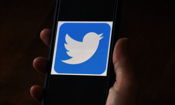 A Twitter logo is displayed on a mobile phone, in Arlington, Va., on May 27, 2020. (Olivier Douliery/AFP via Getty Images)