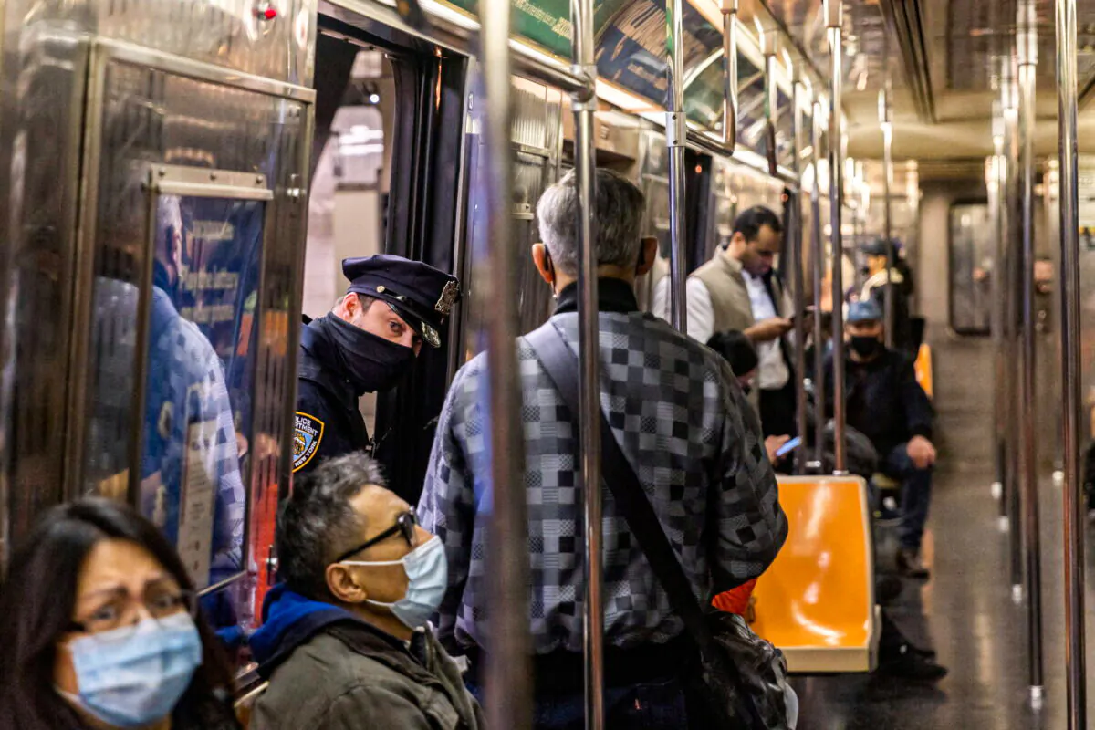 A police officer patrols in Times Square station, after a shooting at a subway station in Brooklyn borough, in Manhattan, New York City, N.Y., on April 12, 2022. (Jeenah Moon/Reuters)