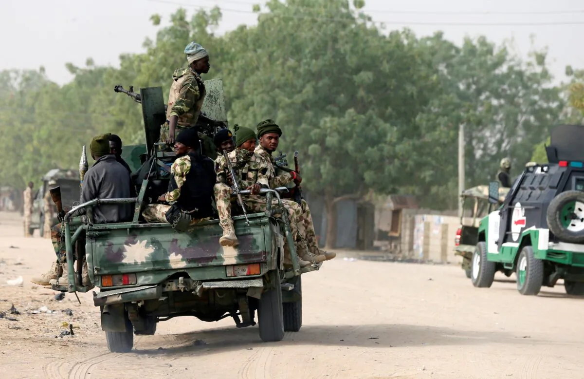 Nigerian military ride on their truck as they secure the area where a man was killed by suspected militants during an attack around Polo area of Maiduguri, Nigeria, on Feb. 16, 2019. (Afolabi Sotunde/Reuters)