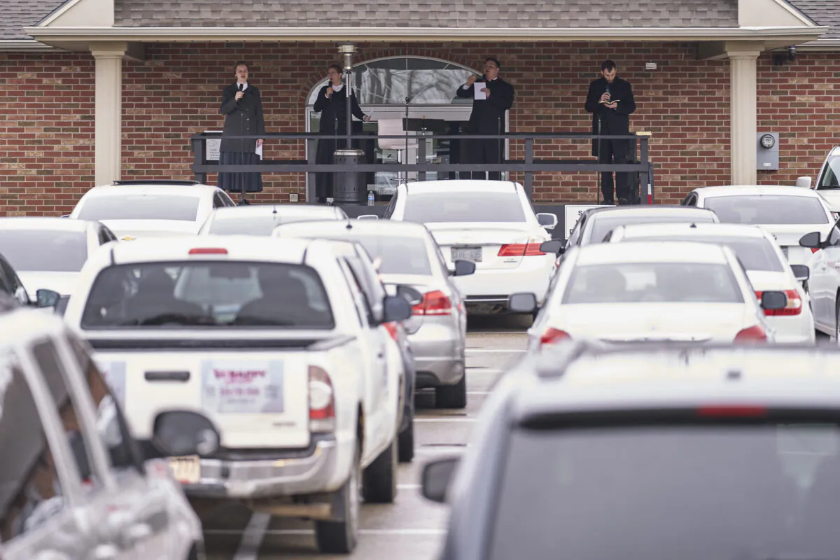 A choir sings while socially distanced during a drive-in service at the Church of God in Aylmer, Ont., on April 26, 2020. (Geoff Robins/The Canadian Press)