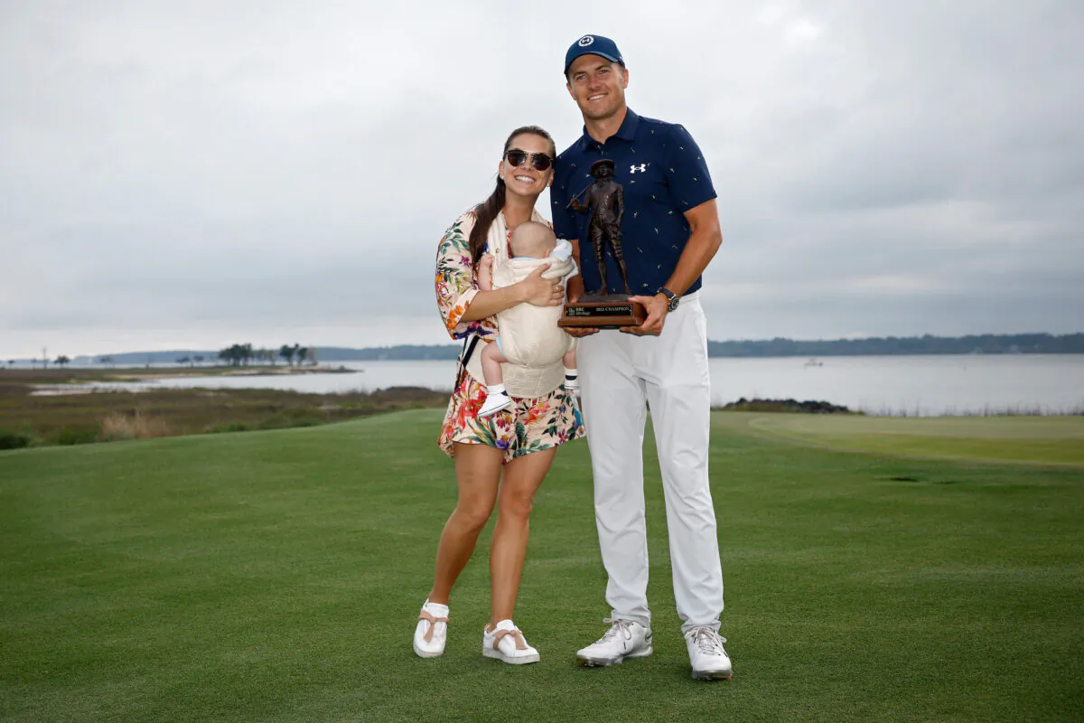 Jordan Spieth poses with the trophy with wife Annie Verret and son Sammy Spieth after winning the RBC Heritage in a playoff at Harbor Town Golf Links, in Hilton Head Island, South Carolina, on April 17, 2022. (Jared C. Tilton/Getty Images)