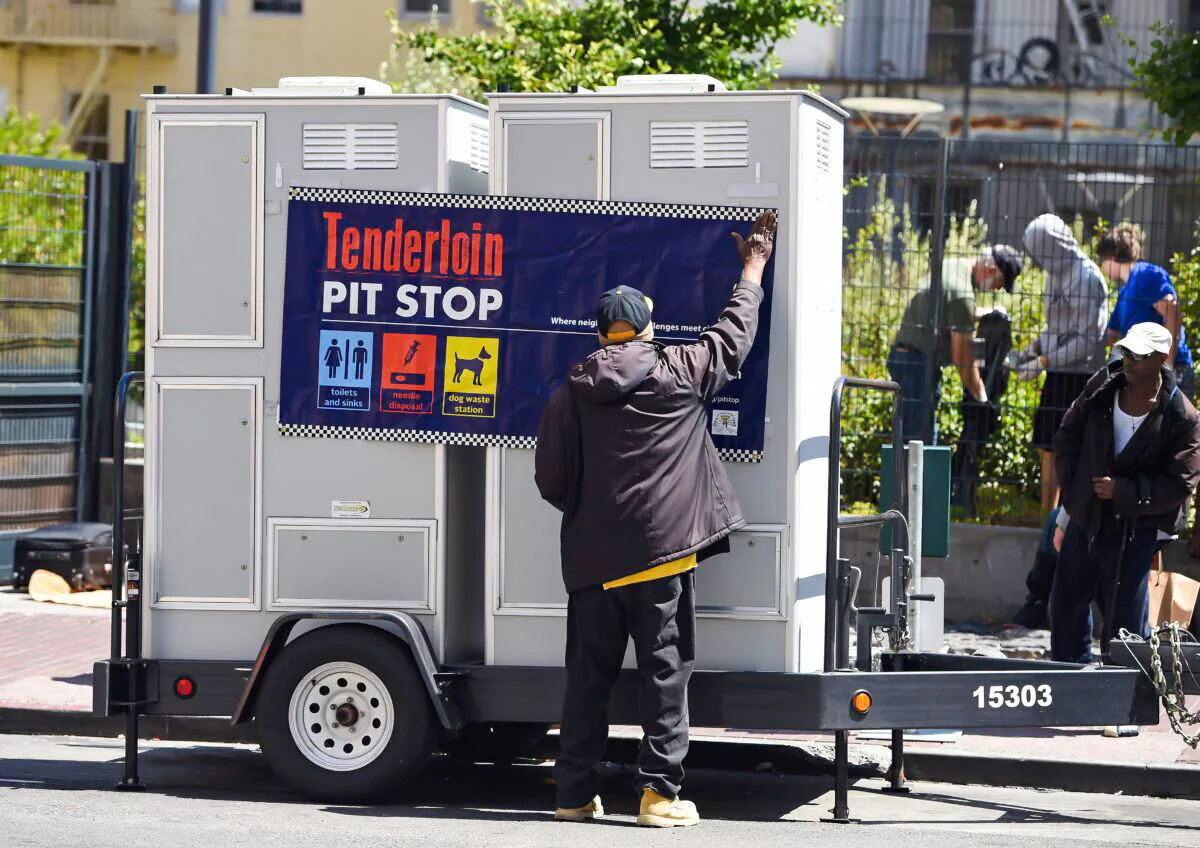 John Leggett helps to install portable toilets in the Tenderloin district of San Francisco on June 28, 2016. The Tenderloin district is commonly known as a hotbed for homelessness where people often relieve themselves on the streets. (Josh Edelson/AFP via Getty Images)