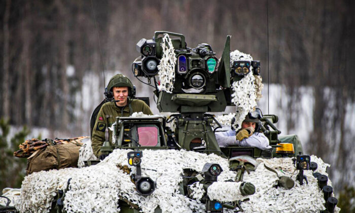 Soldiers from the Norwegian Armed Forces operate a tank as they participate in the international military exercise Cold Response 22, at Setermoen, North of in Norway, on March 22, 2022. (Jonathan Nackstrand/AFP via Getty Images)