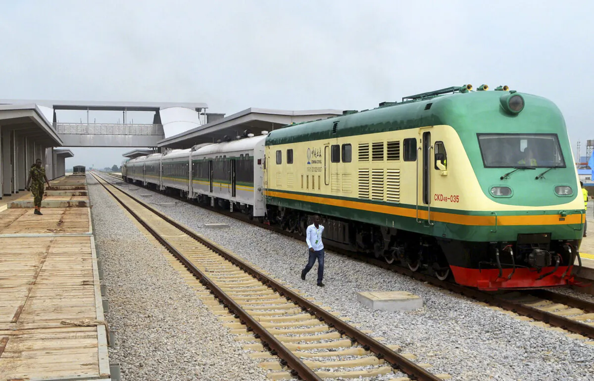 A man walks past a train of the newly completed Abuja-Kaduna night railway line in Abuja, on July 21, 2016. (Stringer/AFP via Getty Images)
