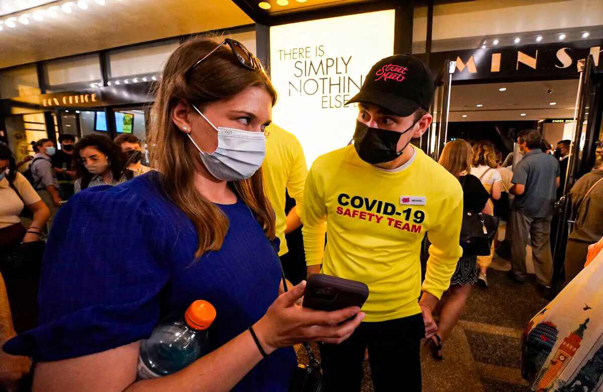 People show their proof of vaccination as they arrive to attend "The Lion King" at the Minskoff Theatre in New York on Sept. 14, 2021. (Timothy A. Clary/AFP via Getty Images)