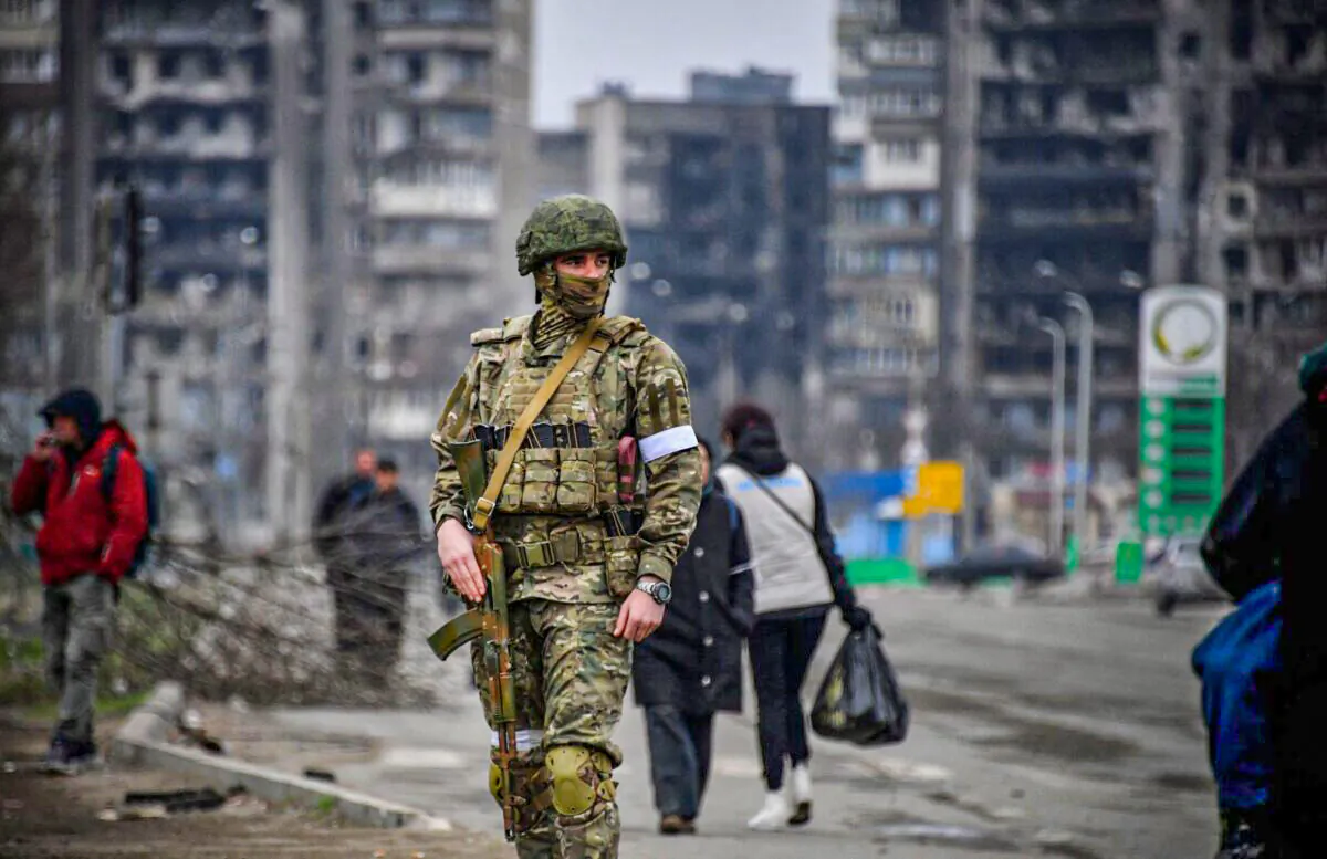 A Russian soldier patrols in a street of Mariupol on April 12, 2022. (Alexander Nemenov/AFP via Getty Images)