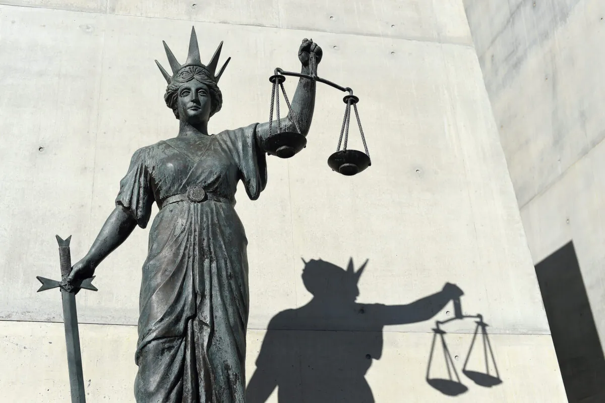 A statue of Themis, the Greek God of Justice stands outside the Supreme Court in Brisbane, Australia, on Oct. 20, 2016. (AAP Image/Dave Hunt)