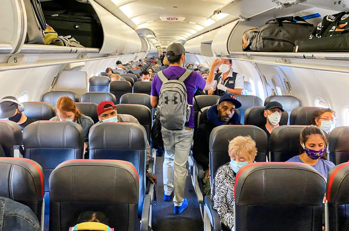 Passengers, almost all wearing masks, board an American Airlines flight to Charlotte, in New York City, on May 3, 2020. (Eleonore Sens/AFP via Getty Images)
