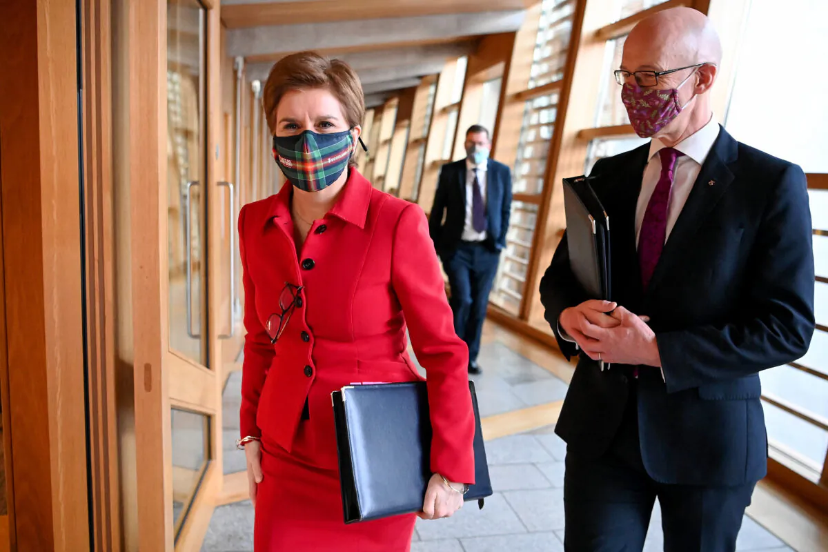 First Minister Nicola Sturgeon and her deputy John Swinney arrive to give a COVID-19 update at the Scottish Parliament in Edinburgh, on Nov. 23, 2021. (Jeff J Mitchell/Getty Images)
