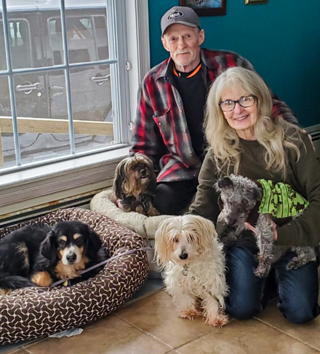 A recent photo of Janet Pfeiffer and her husband and four dogs. Photo courtesy of Janet Pfeiffer)