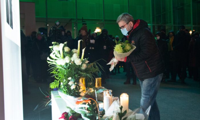 Quebec City Mayor Regis Labeaume lays flowers at a vigil to honour Francois Duchesne who was stabbed to death on Halloween night by a man with a sword, November 3, 2020 in Quebec City. (The Canadian Press/Jacques Boissinot)