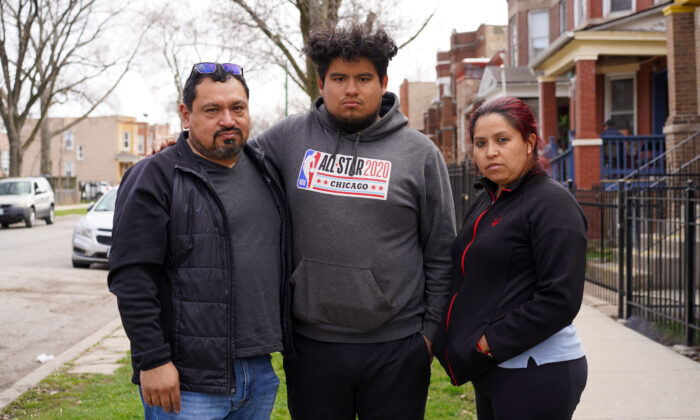 Hugo Limon (left), Hugo Limon Jr., and Patricia Carrillo stand on their block in the Humboldt Park neighborhood on the West Side of Chicago on April 11, 2022. (Cara Ding/The Epoch Times)