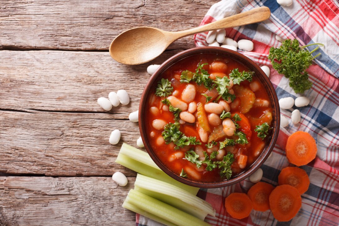 Fasolada is made by simmering beans with tomatoes and other vegetables. In this recipe, zucchini, onions, and spinach are used. (AS Food studio/Shutterstock)